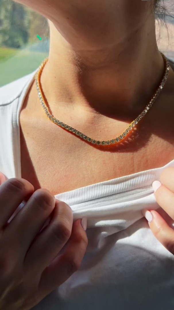 This necklace is simply stunning. The chain is a bright gold, and there are lots of brilliant stones around it. I ordered the 18" necklace, and it fits perfectly on my collarbone. I love wearing it every single day. Love it!!